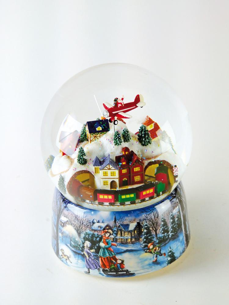 Boule à neige Père Noël en avion