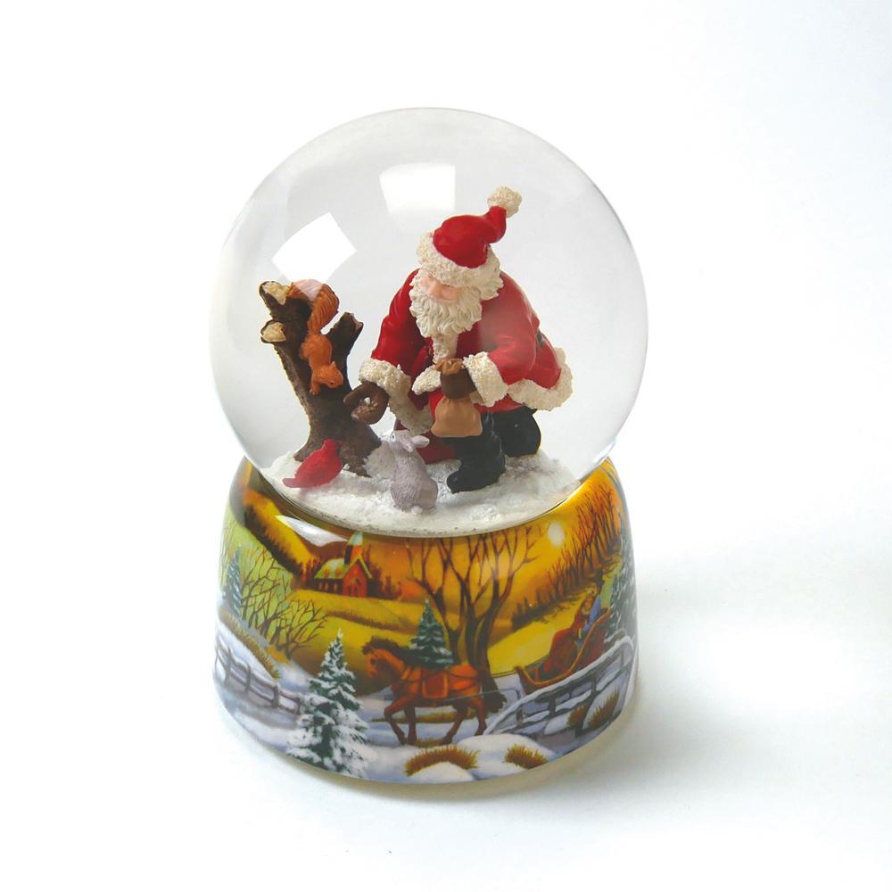 Boule à neige le Père Noël nourri les animaux